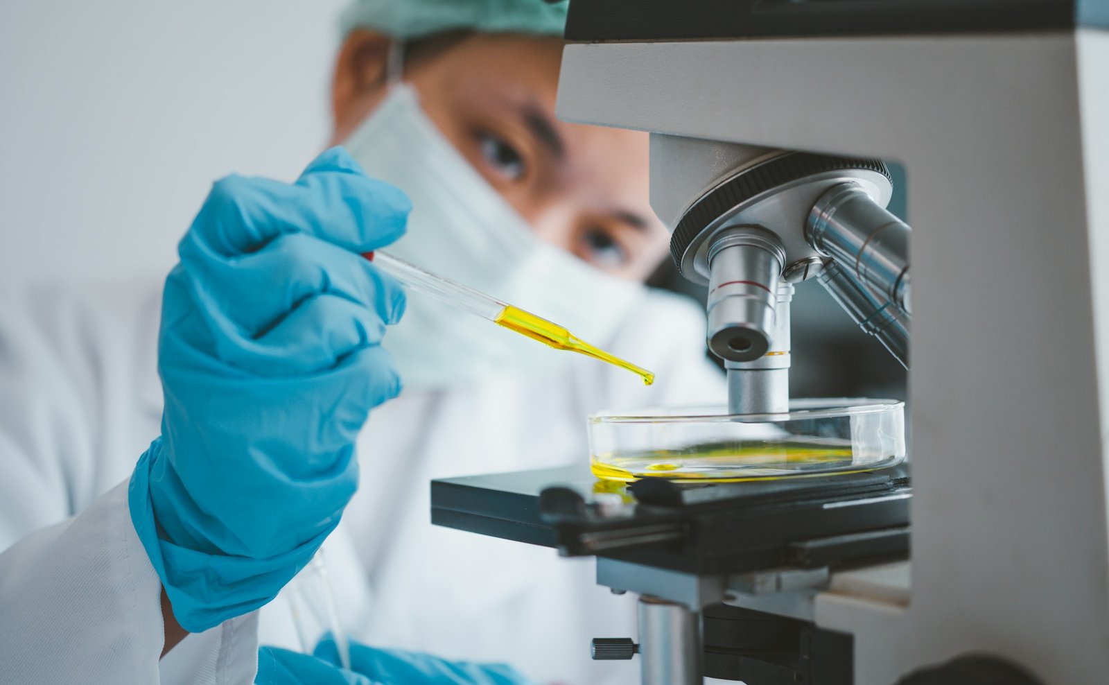 Female researchers are experimenting with pipette dropping a sample into a test